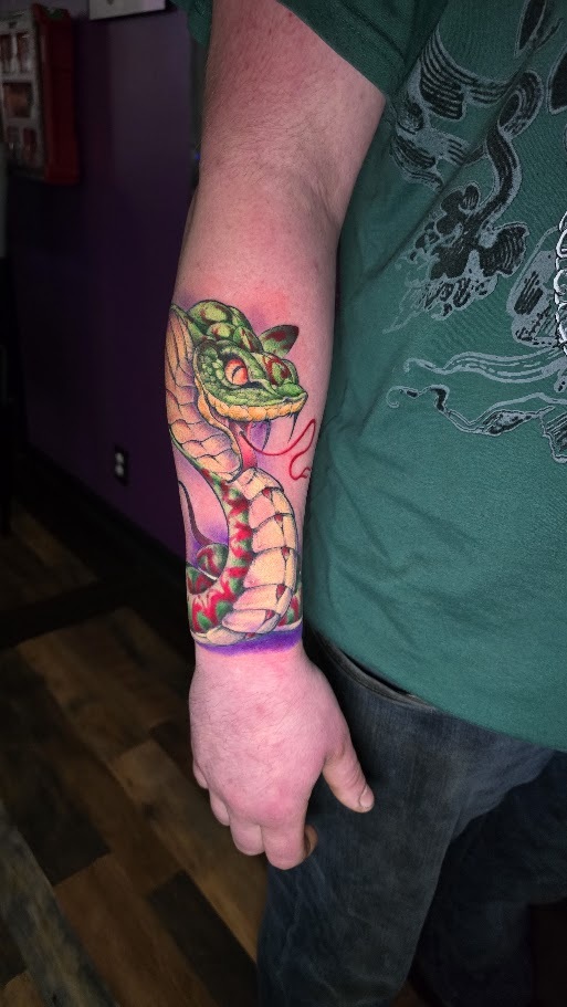 Full color snake forearm tattoo by Billy