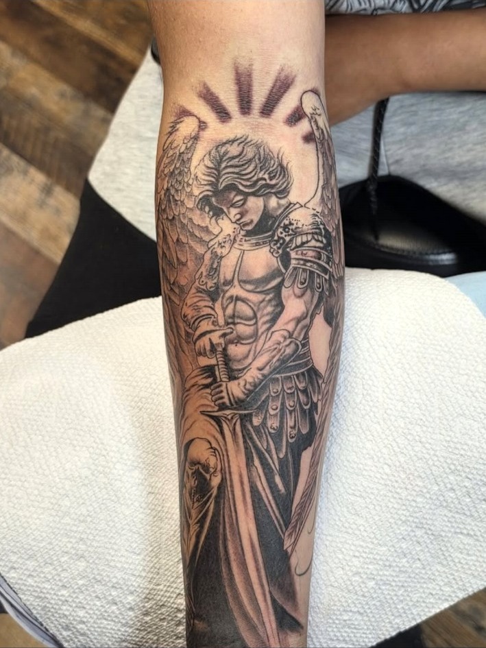Black and grey armored angel forearm sleeve tattoo by Miguel